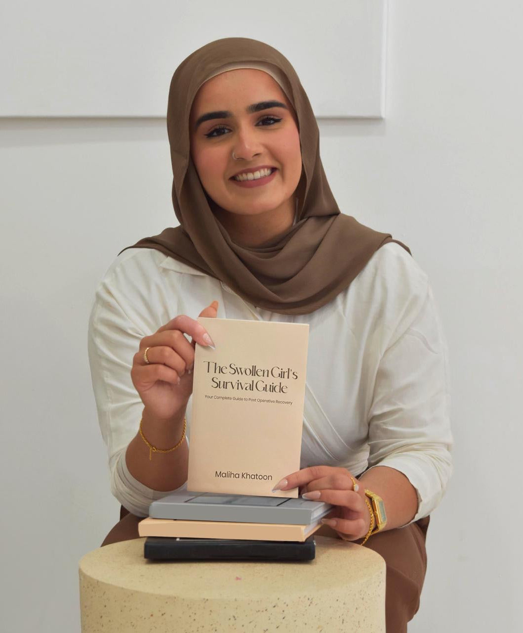 woman holding a recovery guide book for post surgery on white background